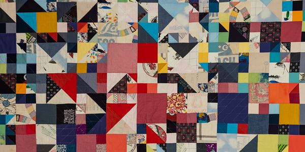 A close-up of a colorful handmade quilt.